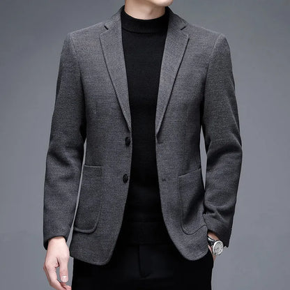 Man wearing a solid colour loose-fit suit-style winter jacket.