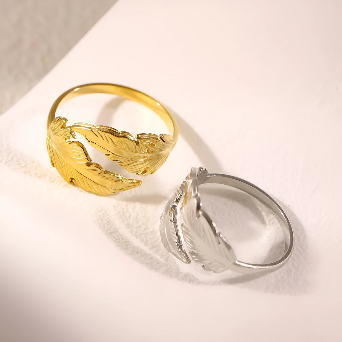 Women's stainless steel feather fashion ring with adjustable opening in silver or gold colour
