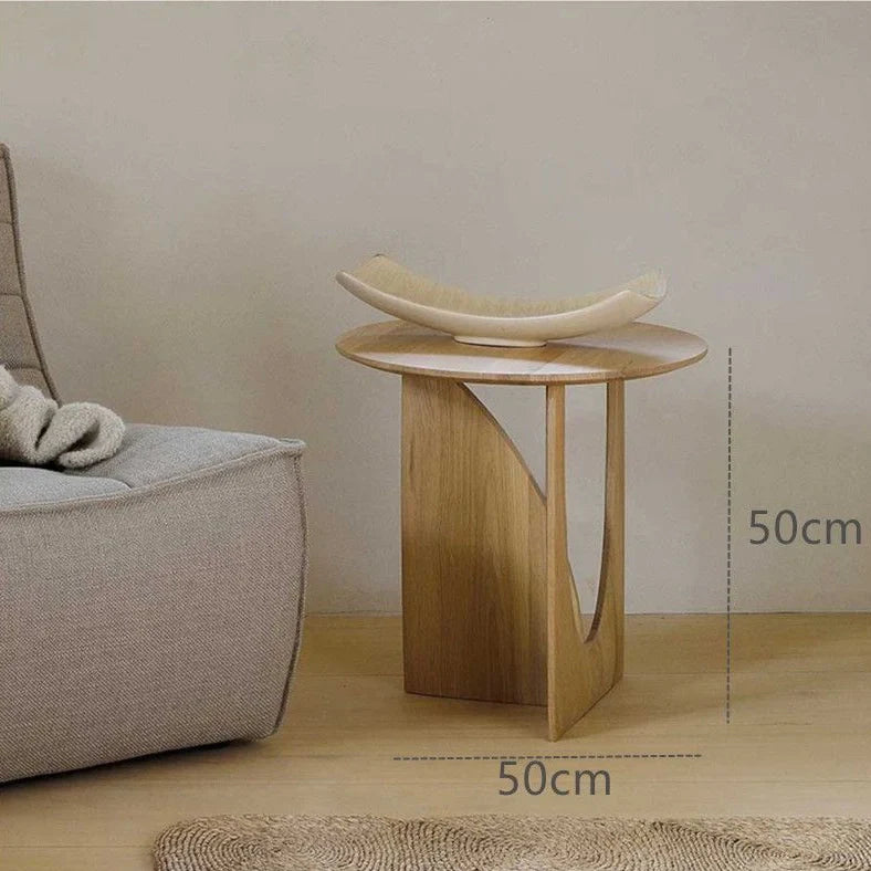 Round solid wood bedside table with geometric legs in walnut finish measuring 50cm diameter