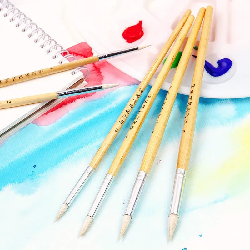 Six wooden-handled pen brushes with pointed wool bristles in conventional colours for artistic line work