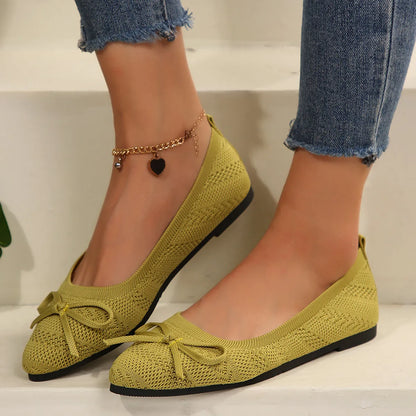 Women's blue knitted loafer flat shoes with a pointed toe and decorative bow detail on the front.