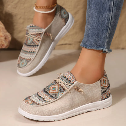 Women's black slip-on flat shoes with round toe and low-top design on a neutral background.