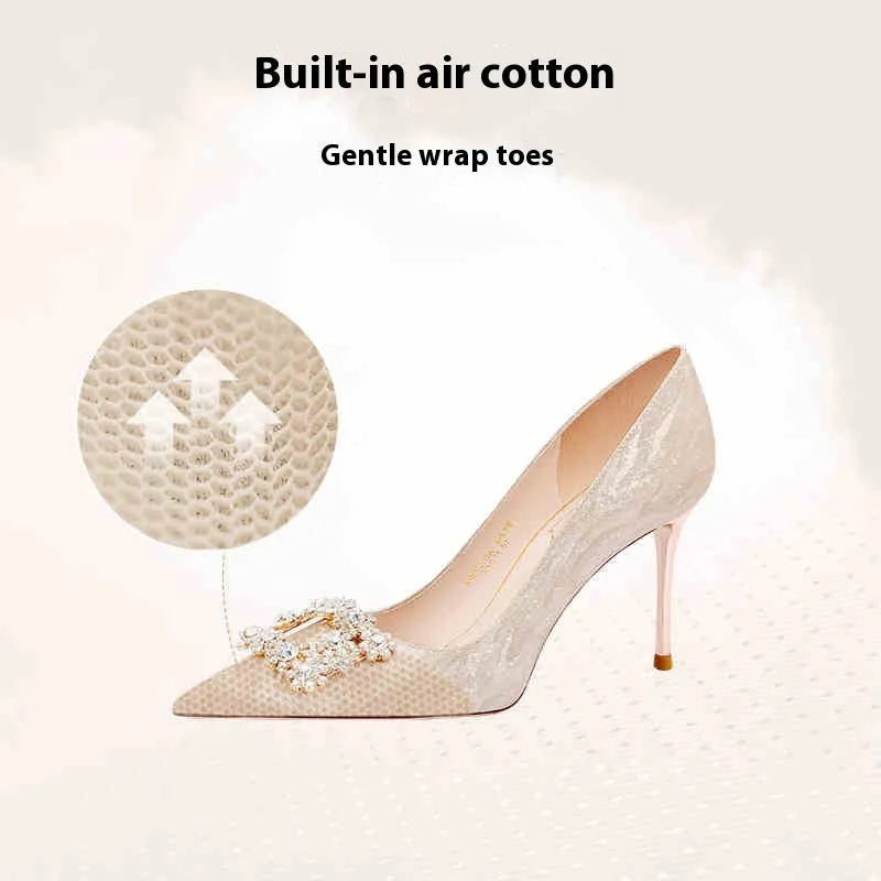Champagne gold pointed-toe high heel pumps with stiletto heel and rhinestone decoration on the upper.
