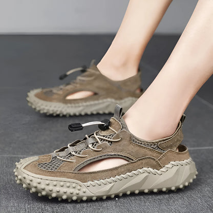 Men's black waterproof wading sandals with elastic band and perforated leather mesh upper on a rubber sole.