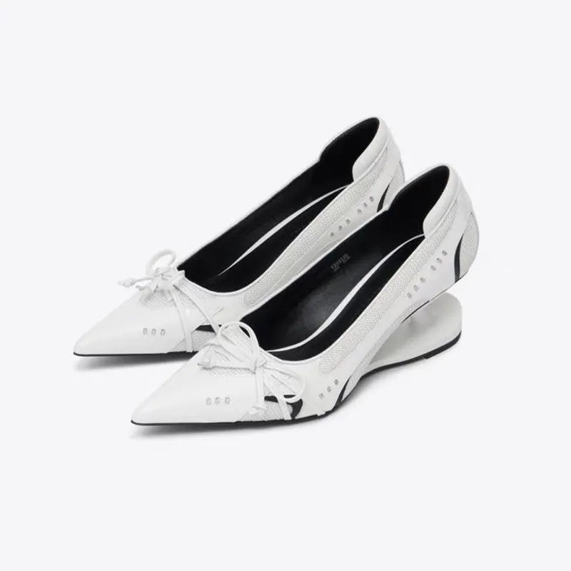Women's black pointed toe shoes with a distinctive floating Mary Jane heel.