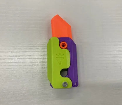 3D printed plastic carrot fidget knife with retractable blade, shown in orange and green colour scheme.