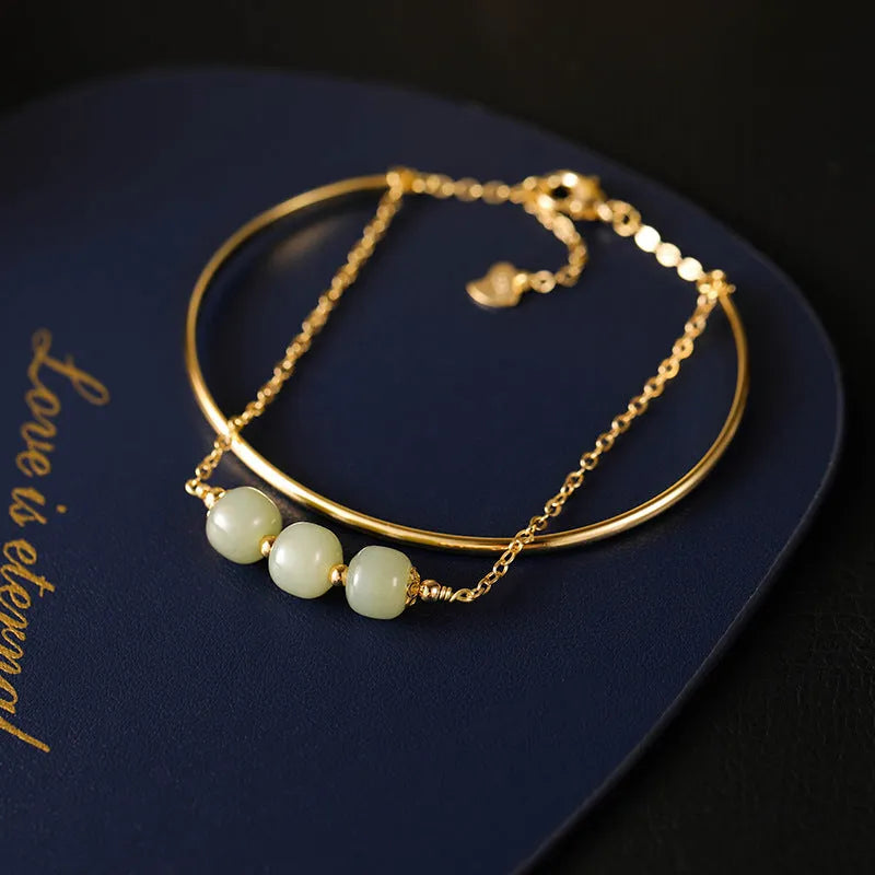 Women's Hetian jade lucky beads bracelet with gold inlay, shown in faux two-piece design.
