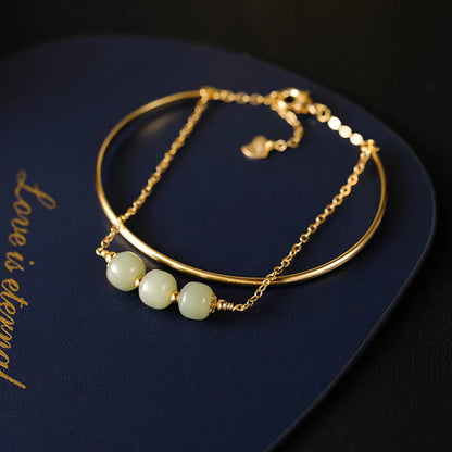 Women's Hetian jade lucky beads bracelet with gold inlay, shown in faux two-piece design.