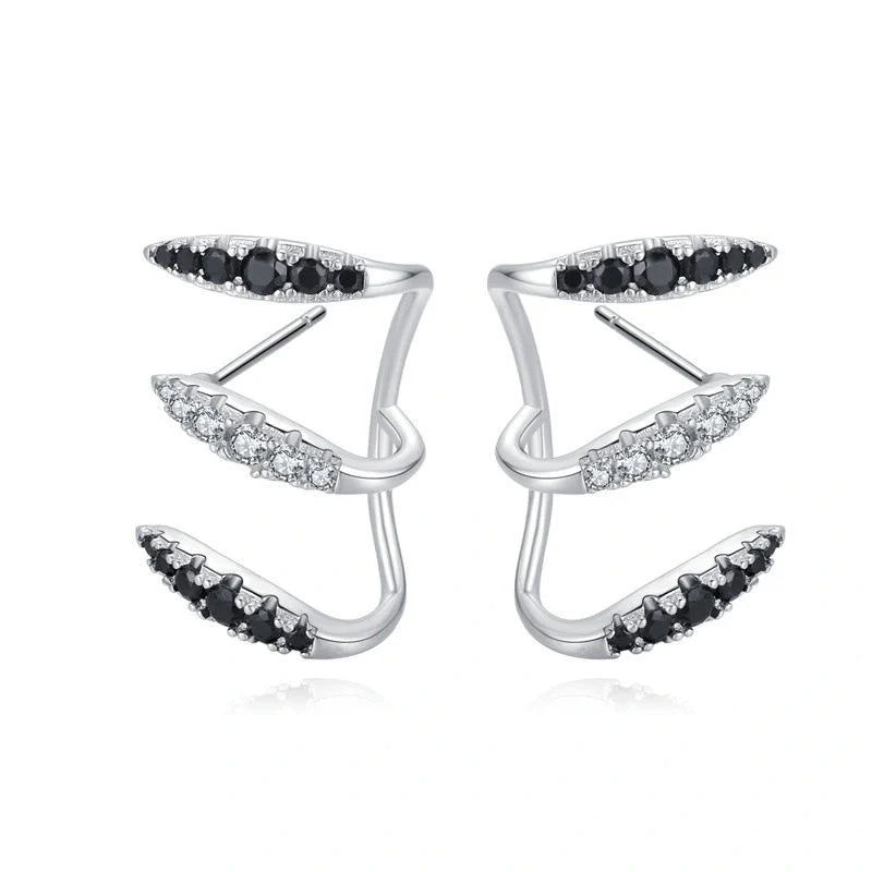 Elegant copper and zircon ear cuffs with a geometric design, showcasing British style and sophistication.