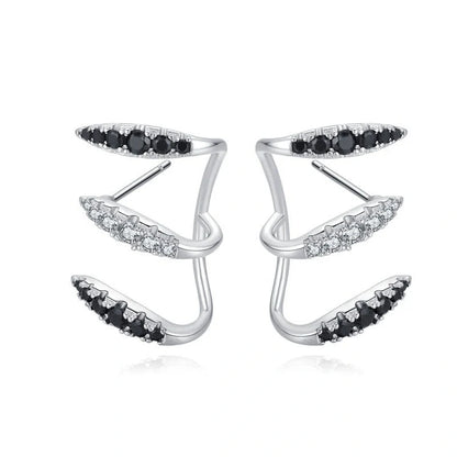 Elegant copper and zircon ear cuffs with a geometric design, showcasing British style and sophistication.
