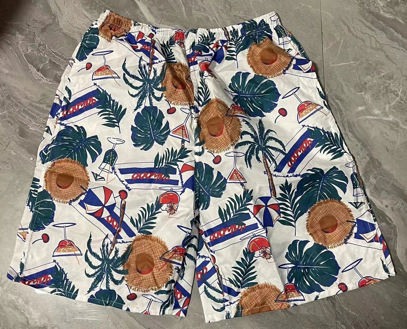 Men's floral patterned swim shorts with five-point cut design
