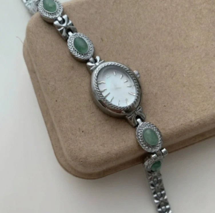 Green jade and silver ladies watch with white dial showing modern Chinese design