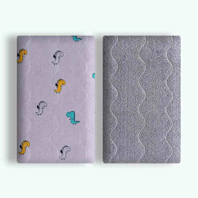 Double-sided cotton wool pet blanket in dinosaur print showing reversible construction