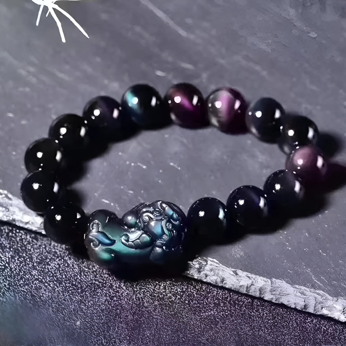 Natural Ice Colour Eye Obsidian crystal bracelet on wrist, showing translucent beads.