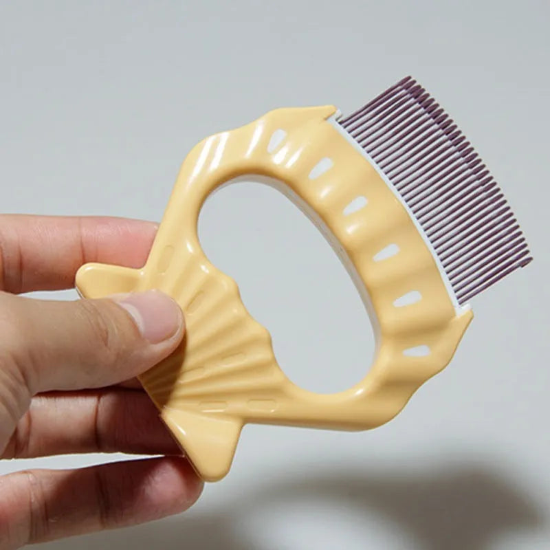 Green shell shaped pet grooming comb with bent wire bristles for removing loose hairs from dogs and cats