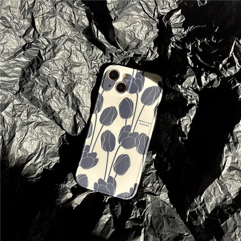 Black silicone iPhone case with a tulip floral pattern on the back.