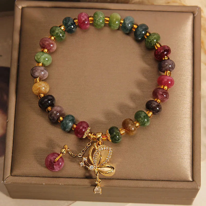 Close-up of a women's colourful butterfly bracelet with alloy construction, colourful beads, and tourmaline details.