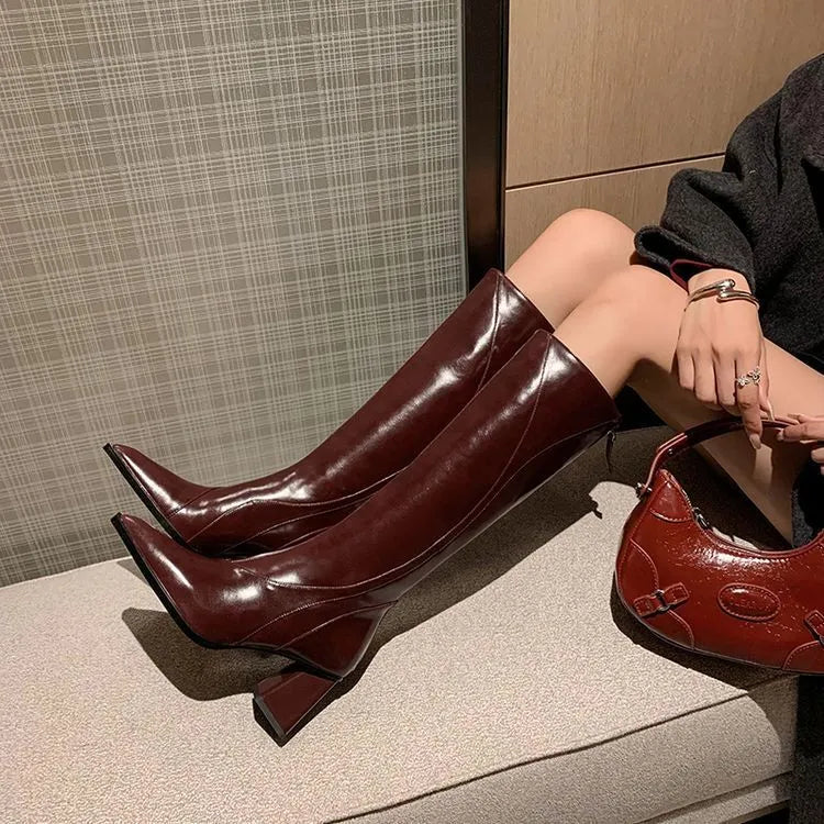 Women's black retro high heel riding boots with a waterproof platform and cowhide upper.