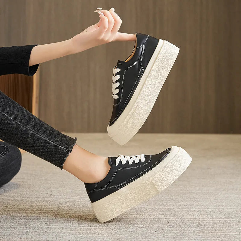 Women's black platform casual shoes with round toe and tied laces on a rubber sole.