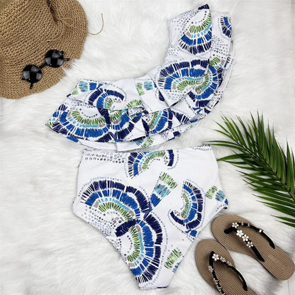 White women's one-shoulder swimsuit with draped lotus leaf design and high-leg split on a model