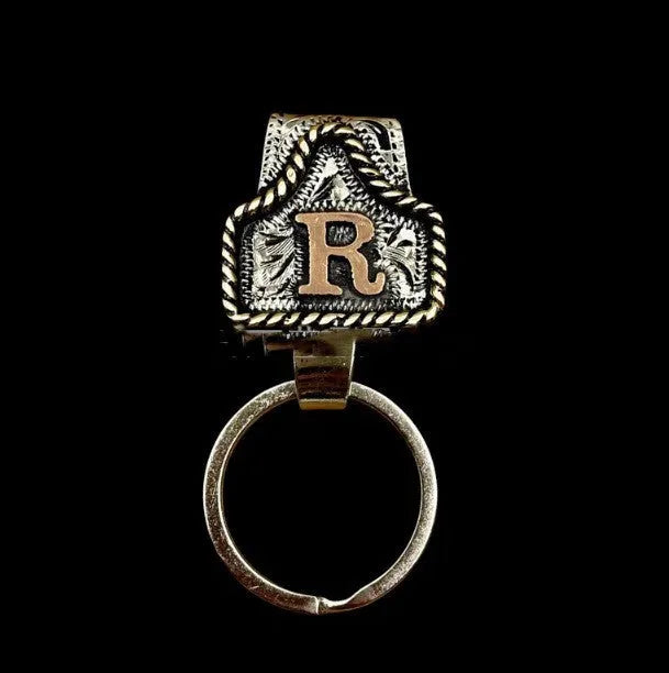 Handmade cow tag design metal keychain on a keyring, shown in one of many available colours.