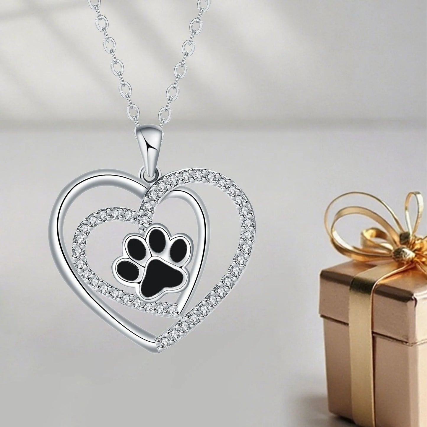 Women's dog paw print necklace with heart-shaped copper pendant on cross chain