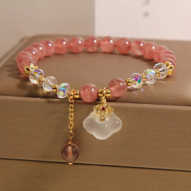 Women's strawberry quartz and white agate crystal bracelet with auspicious cloud charms on elasticated cord
