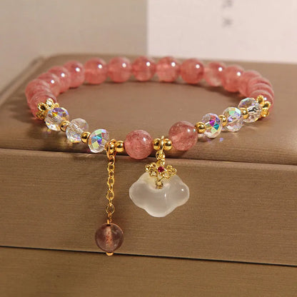Women's strawberry quartz and white agate crystal bracelet with auspicious cloud charms on elasticated cord