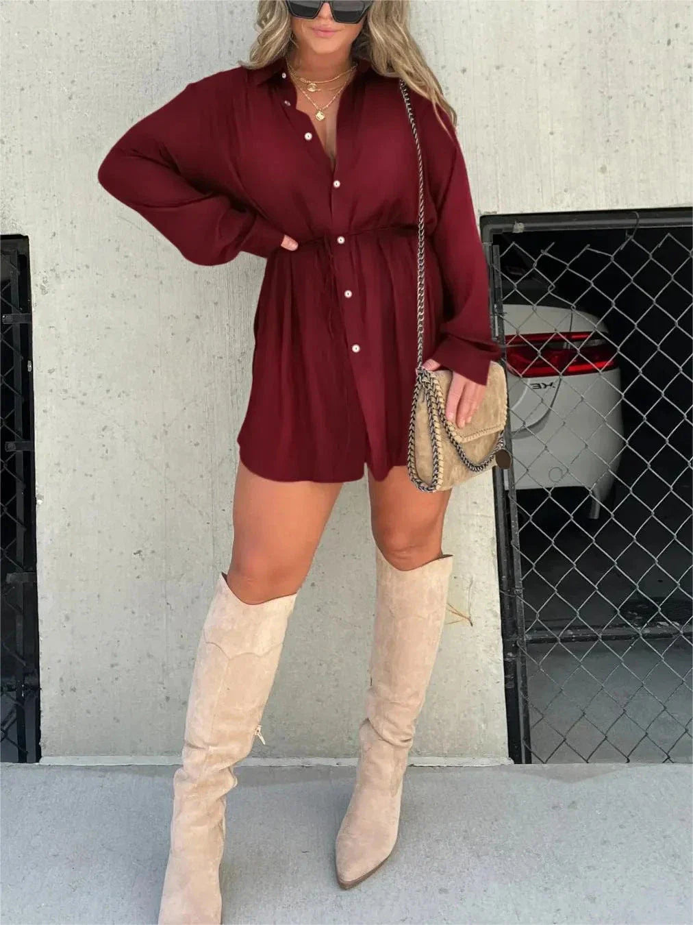 A stylish long sleeve jumpsuit with a button-up shirt design, available in a variety of vibrant colors.