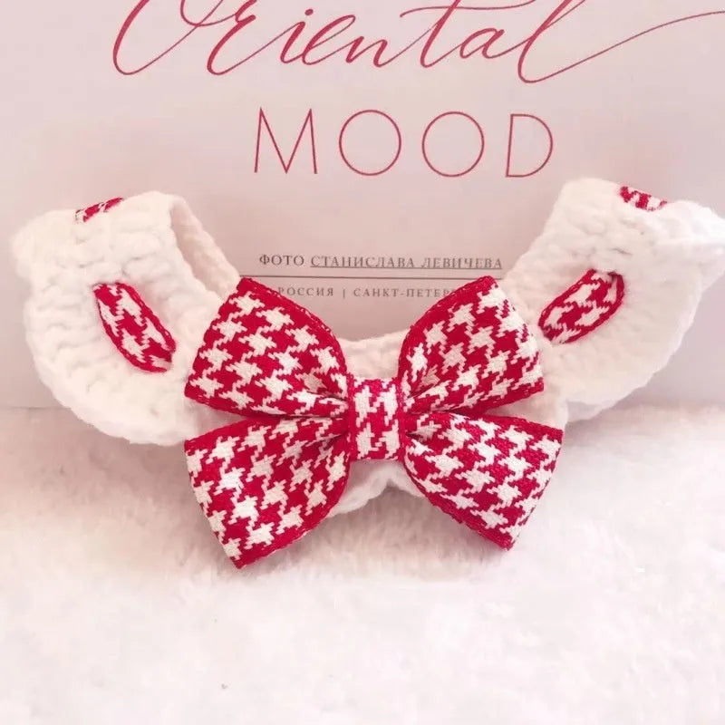 Red and black houndstooth patterned wool knitted collar for pets on a white background.