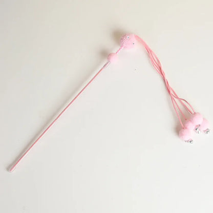 Set of four colourful cat stick toys with dangling tassels, showing blue, pink, and purple handles.