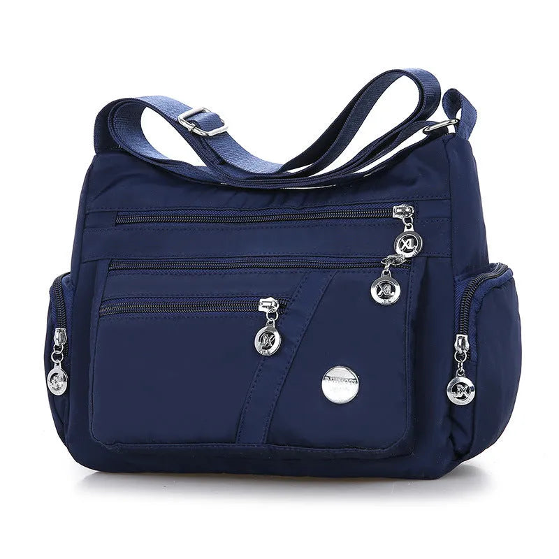 Women's nylon shoulder bag with multi-pocket design, zip opening and detachable handle in red, purple, black or army green
