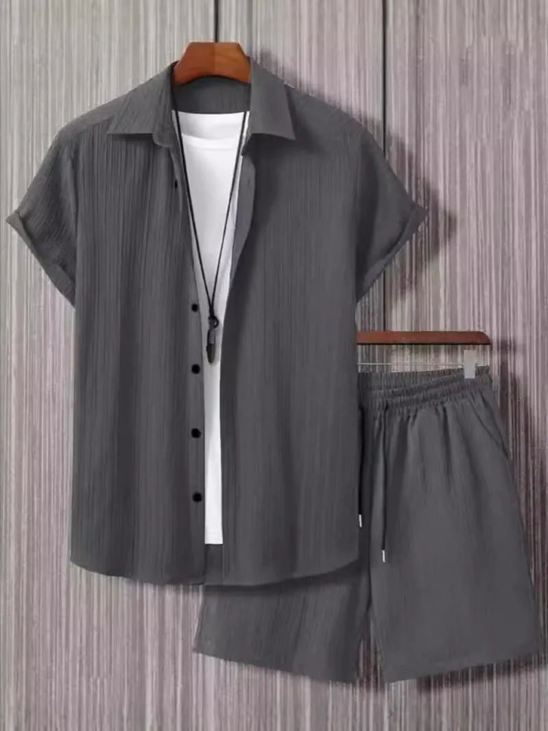 Man wearing a black and white jacquard short sleeve shirt and matching shorts suit set.