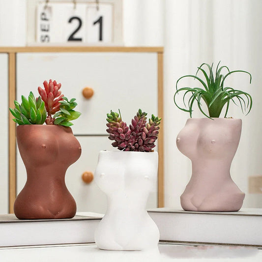 Elegant ceramic flower pots in various colours, featuring intricate designs inspired by classic European styles