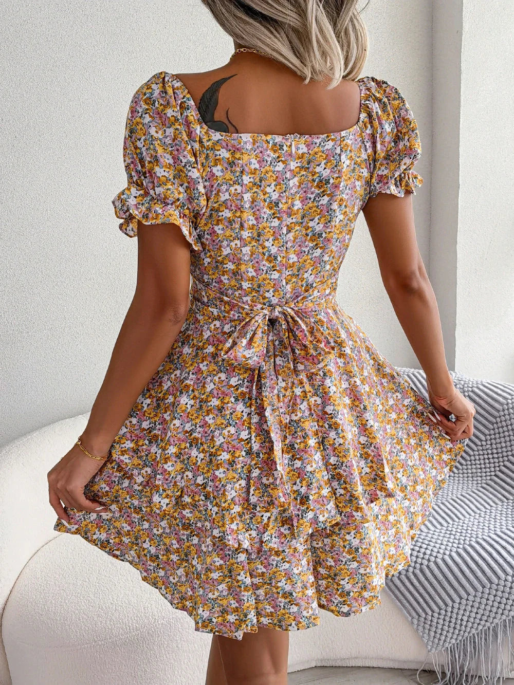 Stylish floral mini dress with ruffled skirt, high-waist design, and short sleeves for a flattering and comfortable summer look