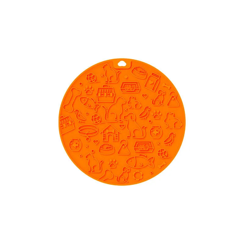 Round blue silicone pet licking mat with textured surface and a clear central suction cup, shown on a tile floor.