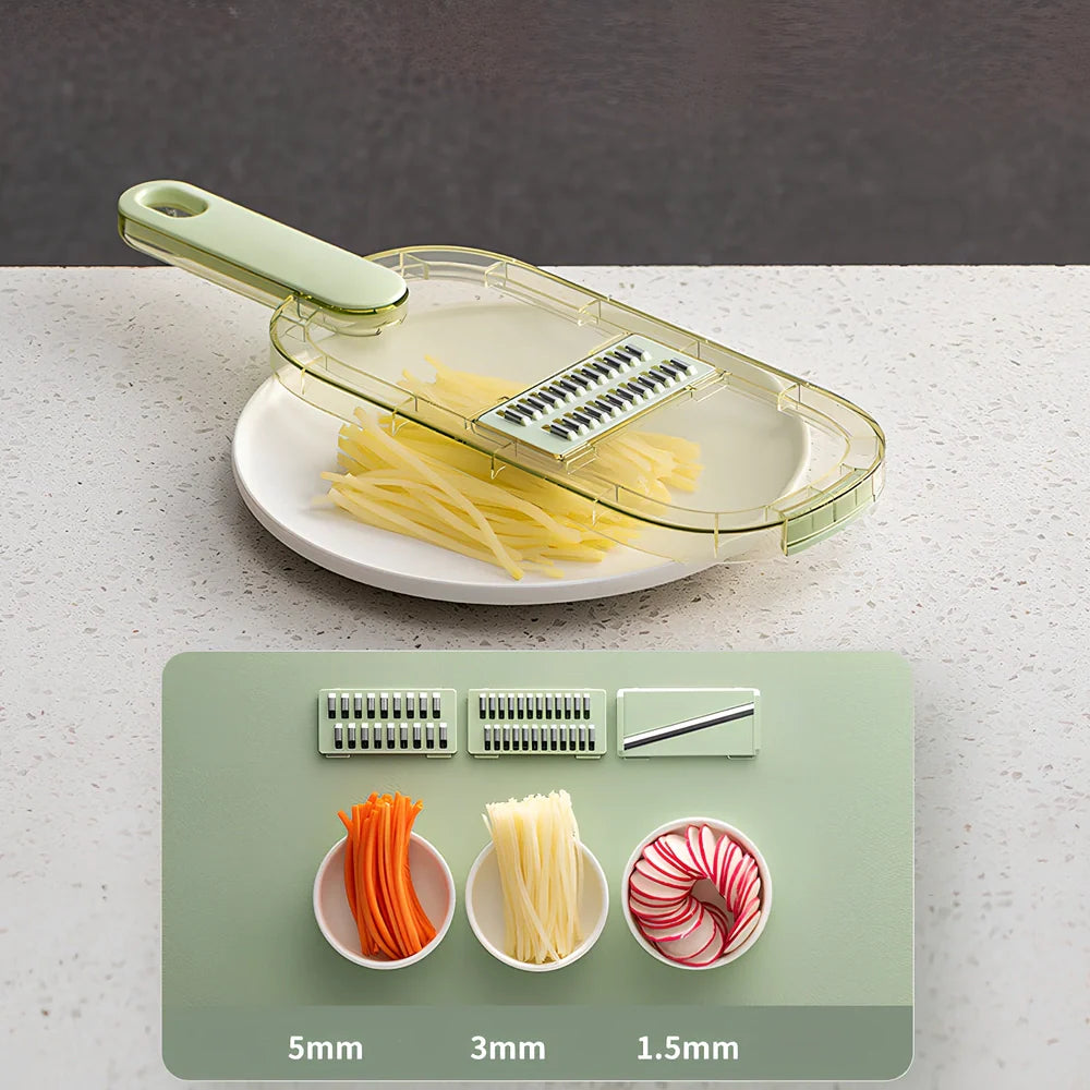Shredded vegetable slicer with stainless steel blades on green cutting board