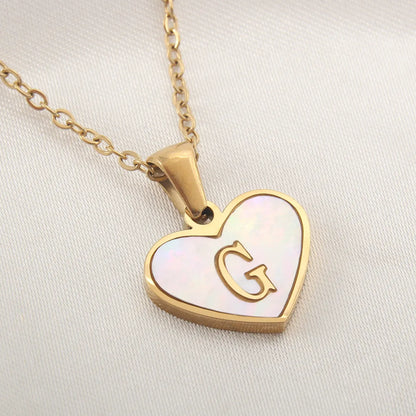 Gold-plated heart necklace with white shell pendant showing letter personalisation option