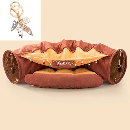 Collapsible cloth cat tunnel in pink colour, shown in both open and folded positions.