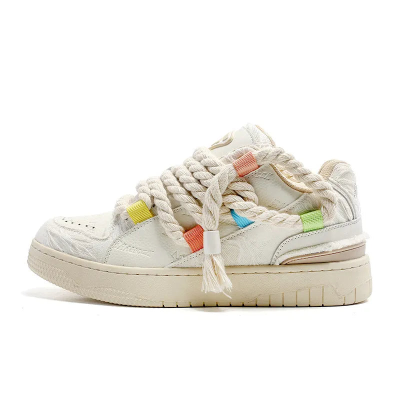 Creamy white old damage lace-up retro skateboard shoes with platform heel on a rubber sole.