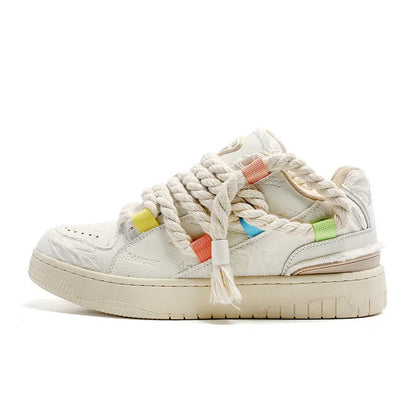 Creamy white old damage lace-up retro skateboard shoes with platform heel on a rubber sole.