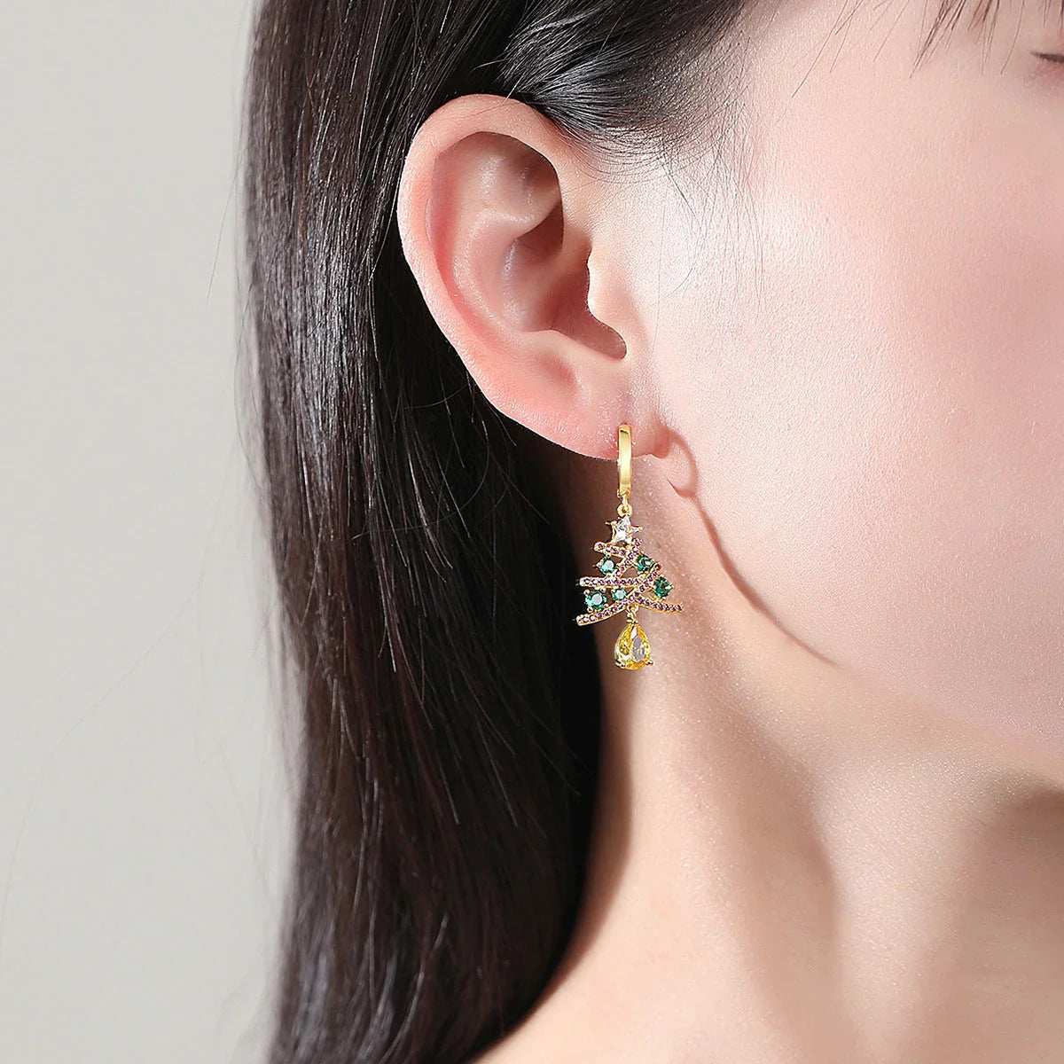 Shimmering gold Christmas tree earrings with colorful rhinestones, a must-have holiday fashion accessory