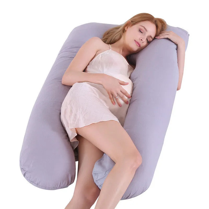 Light blue U-shaped ice silk maternity pillow for pregnancy support on a bed