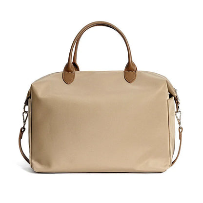 Waterproof nylon shoulder bag with leather accents in black or light khaki, showing 35cm width.