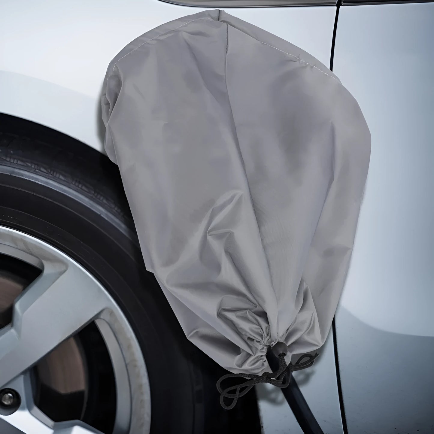 Grey waterproof cover for electric vehicle charging port with drawstring closure