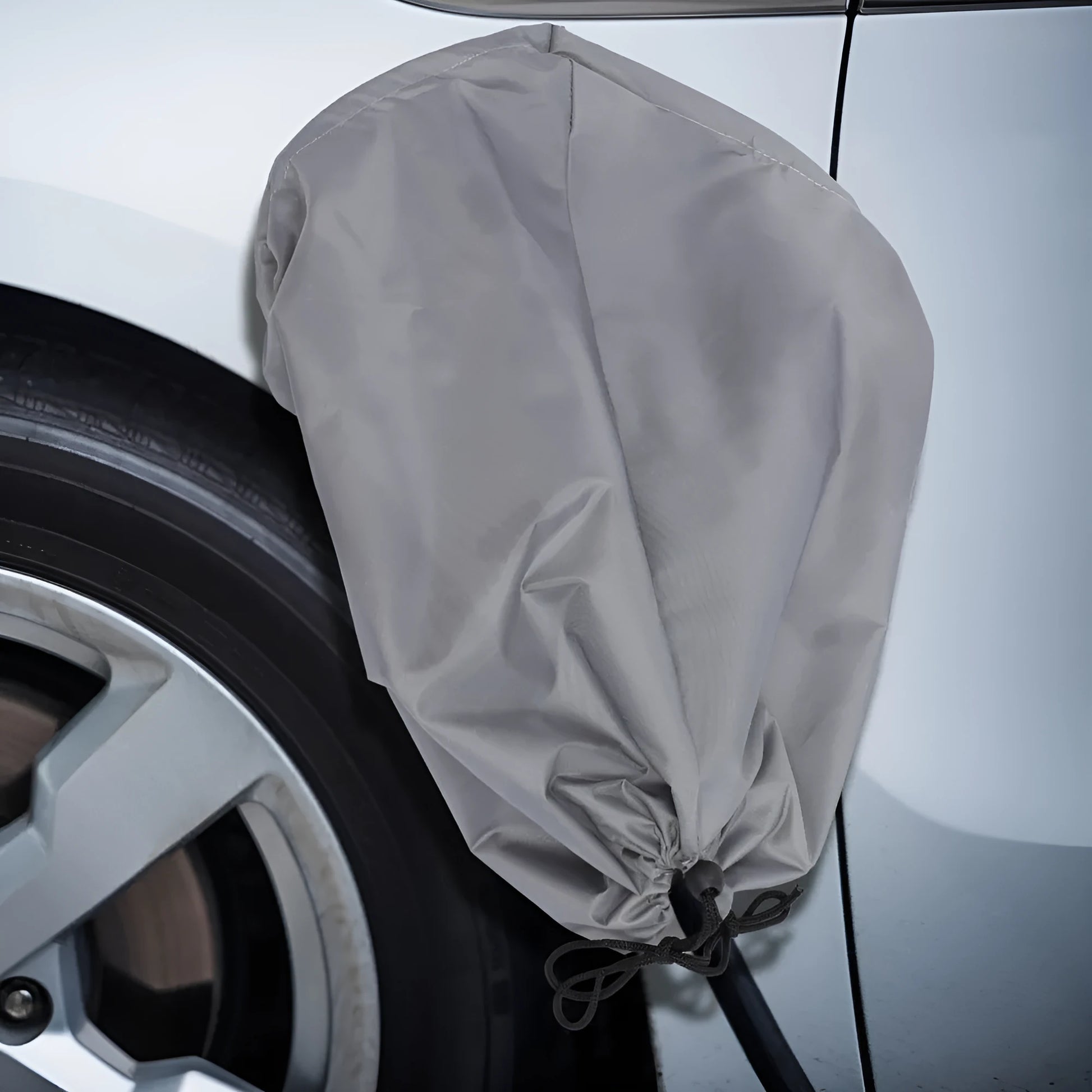 Grey waterproof cover for electric vehicle charging port with drawstring closure