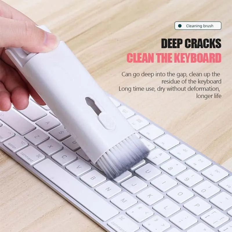 White electronics cleaning kit with a cleaning pen, spray bottle, brush, and keycap puller on a table