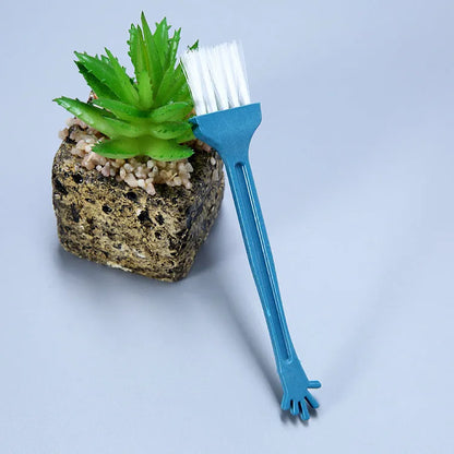 Diamond painting repair tool set with metal scraper pen, bottle of adhesive liquid, soft brush, and bamboo stick on a craft table