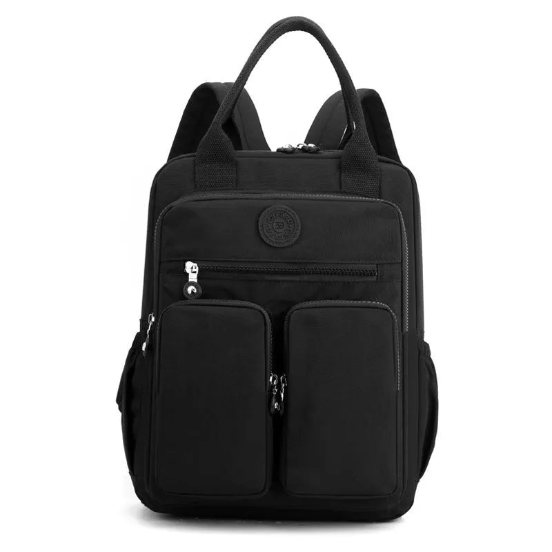 Women's waterproof nylon travel backpack in grey, showing front external pocket and organisational interior.