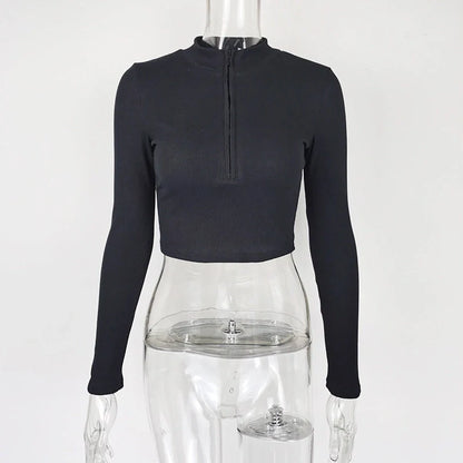 Women's black zip-front crop top with slim fit and long sleeves on hanger